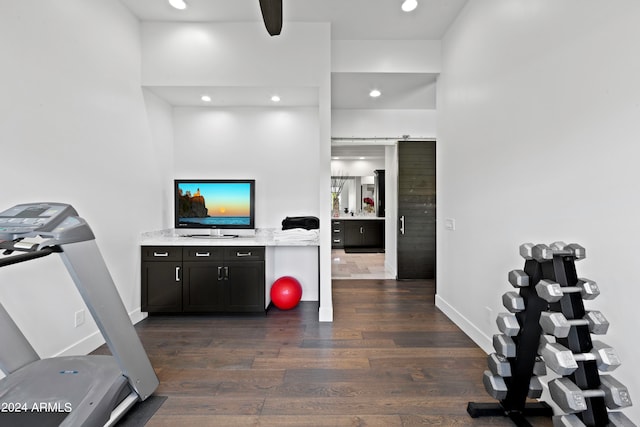 workout area featuring dark wood-type flooring