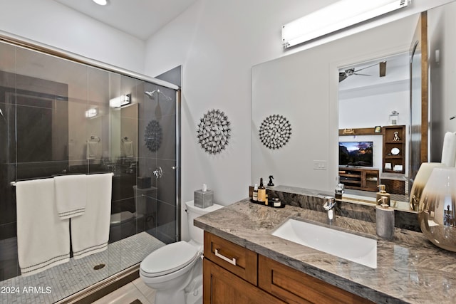 bathroom featuring a wall unit AC, an enclosed shower, ceiling fan, vanity, and toilet