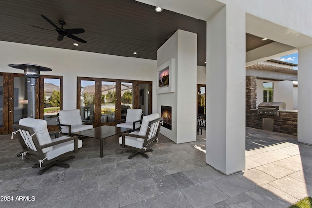 view of patio / terrace with exterior kitchen, area for grilling, and ceiling fan