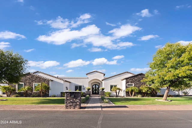 mediterranean / spanish house with a front lawn