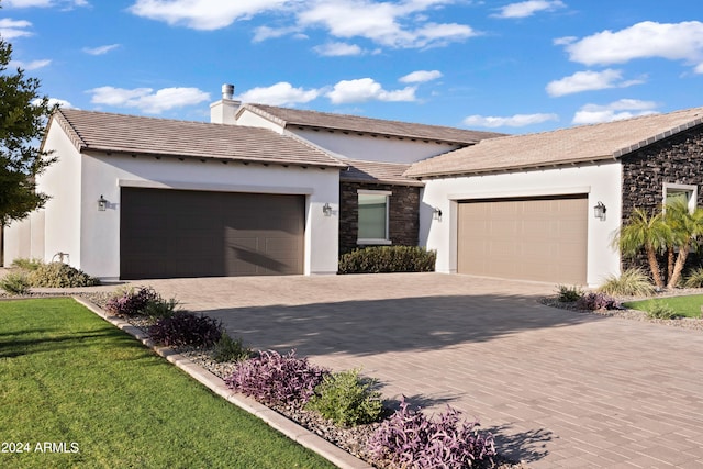 view of front of home featuring a front yard and a garage