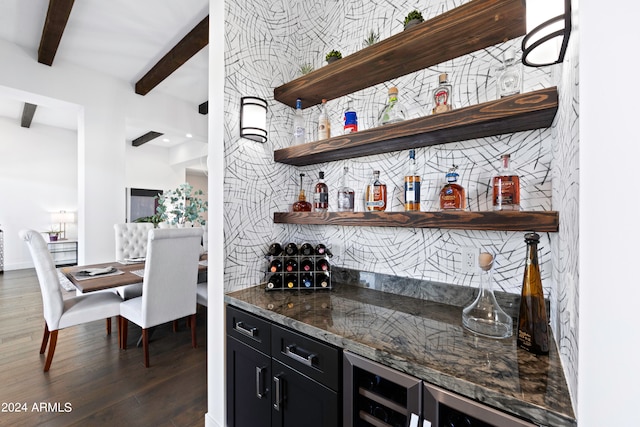 bar with dark stone counters, dark hardwood / wood-style floors, and beamed ceiling