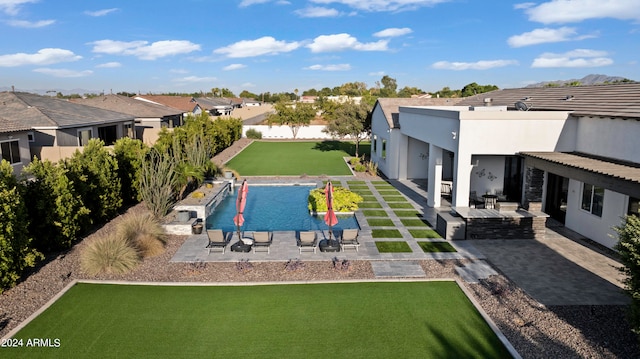 view of swimming pool with a patio and a lawn