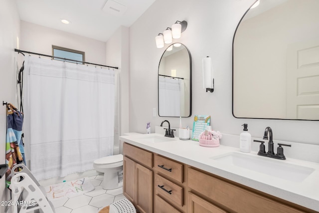 bathroom with tile patterned floors, vanity, and toilet