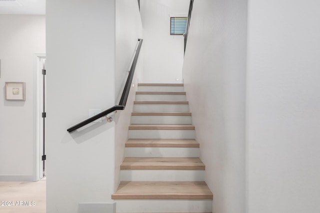 stairway featuring hardwood / wood-style floors