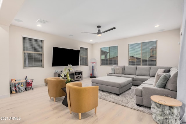 living room with light hardwood / wood-style floors and ceiling fan