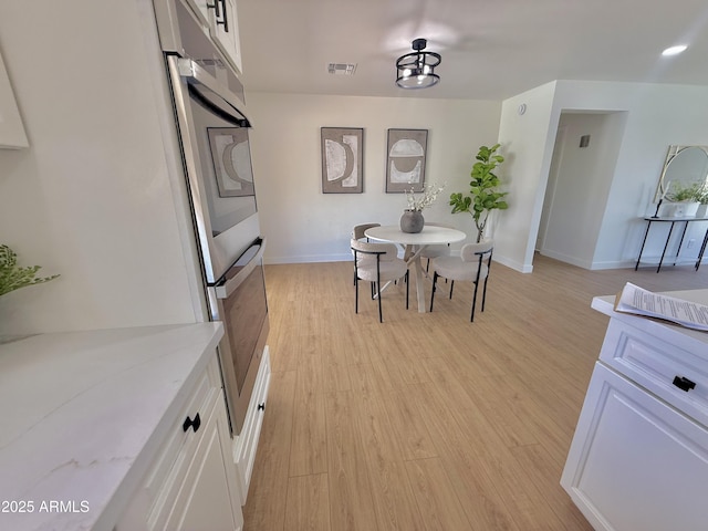 1421 W Pasadena Ave, Phoenix, AZ 85013 - dining area featuring light wood-style flooring and baseboards
