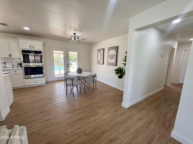1421 W Pasadena Ave, Phoenix, AZ 85013 - dining area with french doors and light wood-style flooring