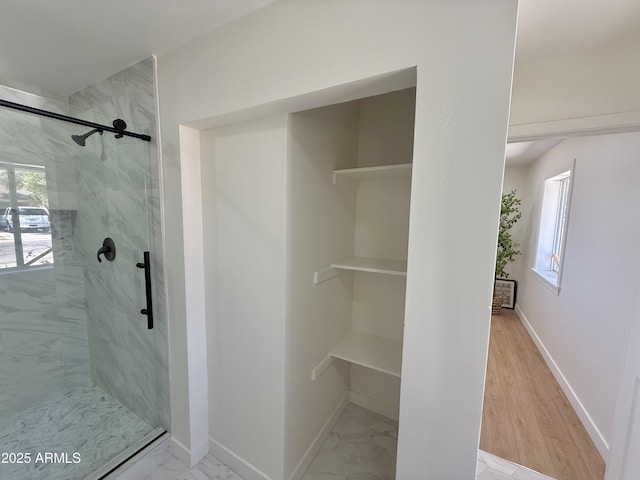1421 W Pasadena Ave, Phoenix, AZ 85013 - full bath featuring a marble finish shower, healthy amount of natural light, and marble look tiles