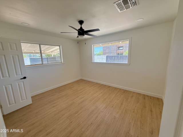 1421 W Pasadena Ave, Phoenix, AZ 85013 - empty room with healthy amount of natural light, light wood-style flooring, ceiling fan, and recessed lighting