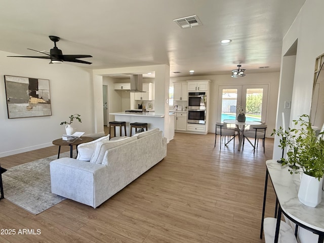 1421 W Pasadena Ave, Phoenix, AZ 85013 - living room featuring light wood-style flooring, french doors, a ceiling fan, and recessed lighting