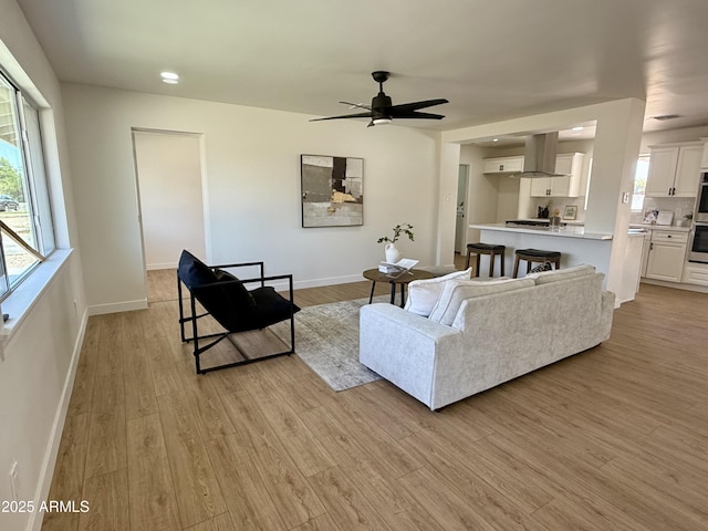 1421 W Pasadena Ave, Phoenix, AZ 85013 - living area with light wood-style flooring, plenty of natural light, and a ceiling fan