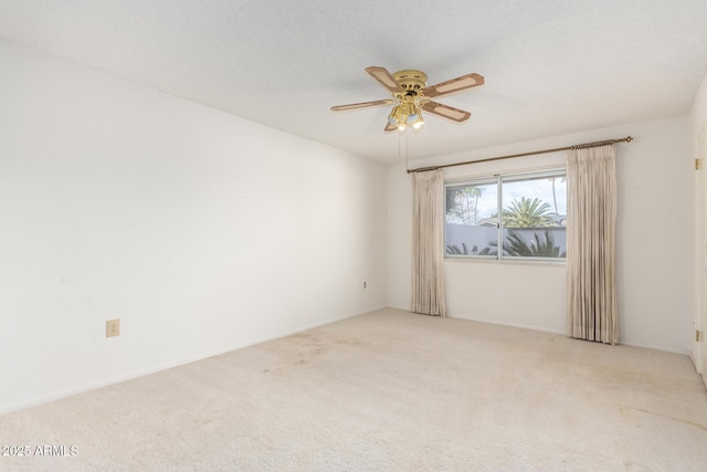 carpeted empty room with a textured ceiling and a ceiling fan