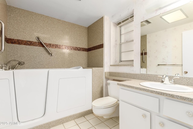 full bath with tile patterned floors, vanity, toilet, and wallpapered walls