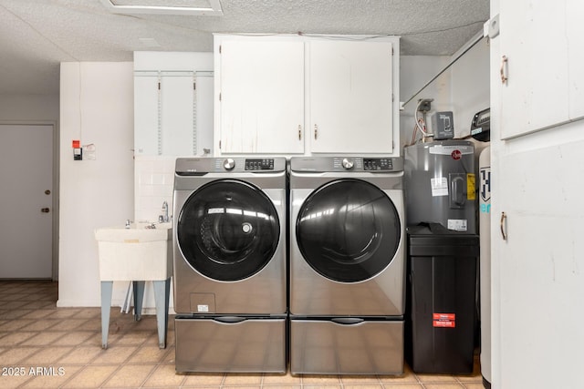 clothes washing area with cabinet space, washer and clothes dryer, and a textured ceiling