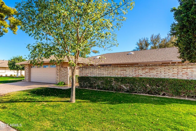 ranch-style house featuring a garage, brick siding, roof with shingles, decorative driveway, and a front lawn