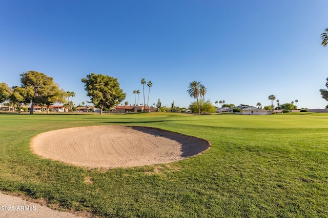 view of community featuring golf course view and a lawn