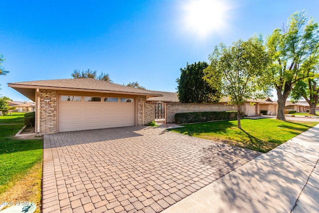 single story home featuring decorative driveway, brick siding, an attached garage, and a front lawn