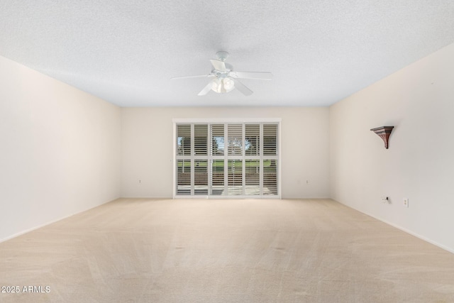 spare room with a ceiling fan, carpet, and a textured ceiling