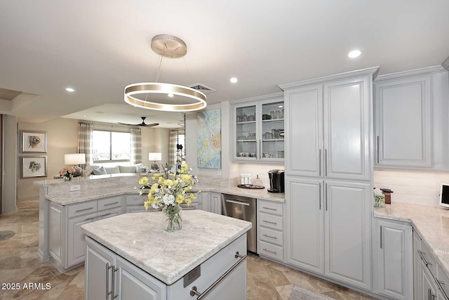 kitchen with open floor plan, a center island, a peninsula, glass insert cabinets, and dishwasher