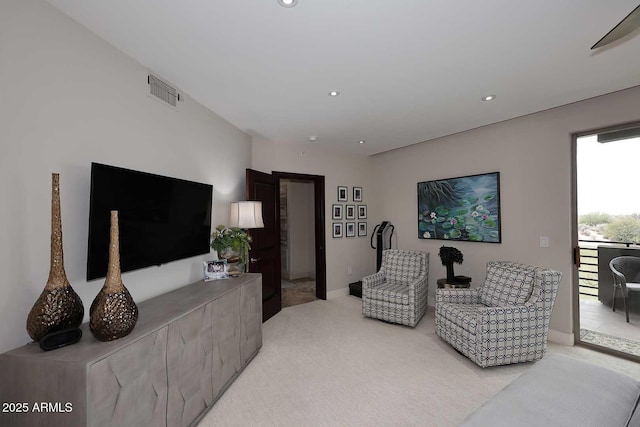 living room with recessed lighting, light colored carpet, and visible vents