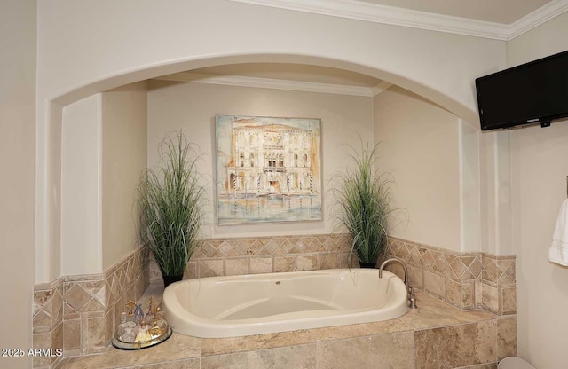 bathroom with crown molding and a bath