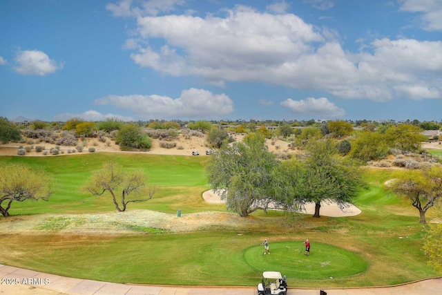 surrounding community featuring golf course view and a yard