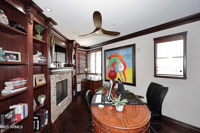 home office featuring crown molding, ceiling fan, baseboards, a fireplace, and dark wood-style floors