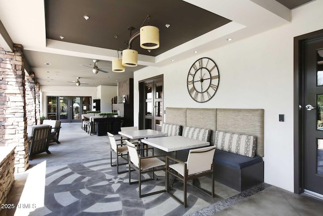 view of patio with french doors, outdoor dining area, and a ceiling fan