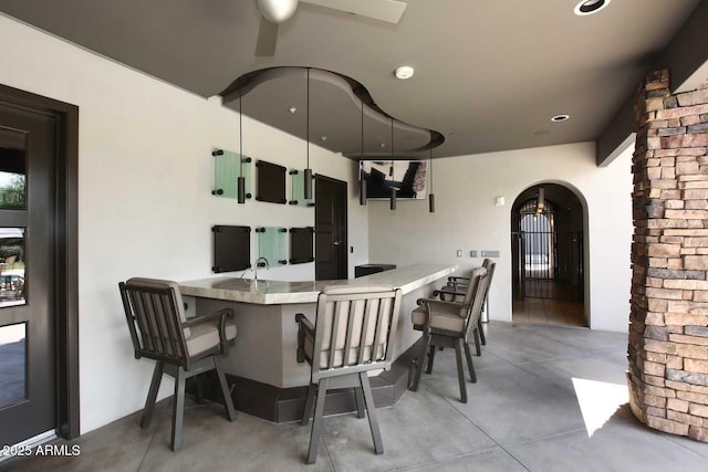 interior space with arched walkways and concrete floors