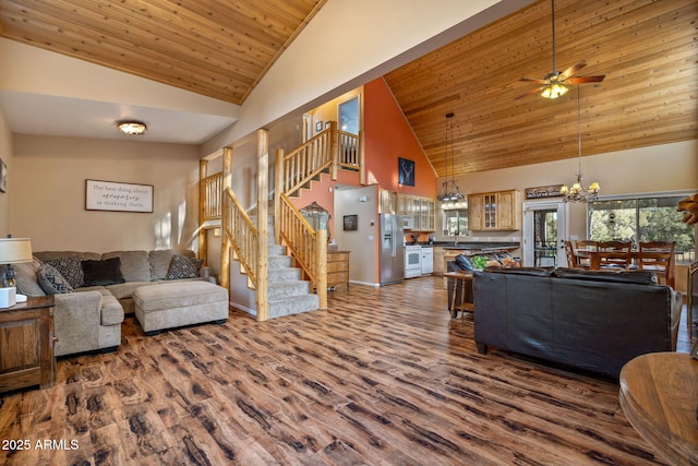 living room with high vaulted ceiling, dark wood-type flooring, stairway, and wood ceiling