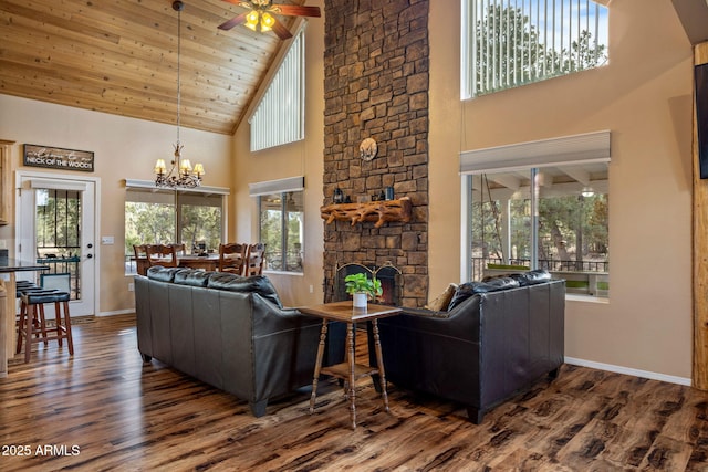 living area featuring a stone fireplace, dark wood-type flooring, wooden ceiling, and baseboards