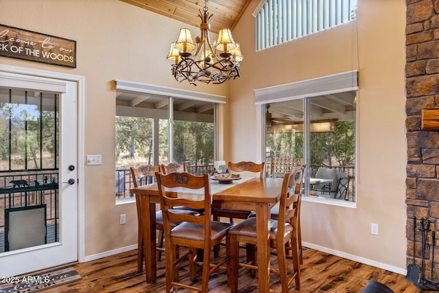 dining room with a notable chandelier, baseboards, and wood finished floors