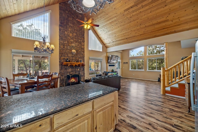 kitchen featuring wood ceiling, a fireplace, open floor plan, and wood finished floors