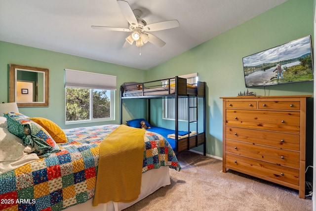 bedroom with lofted ceiling, carpet, baseboards, and ceiling fan