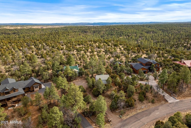 drone / aerial view with a wooded view