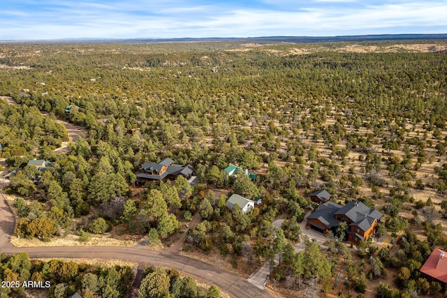 drone / aerial view featuring a view of trees