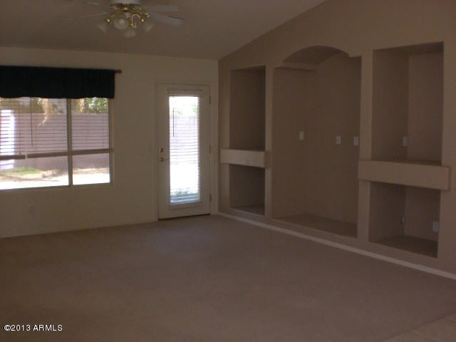 1412 E Oakland St, Gilbert, AZ 85295 - spare room with ceiling fan, vaulted ceiling, arched walkways, and carpet flooring