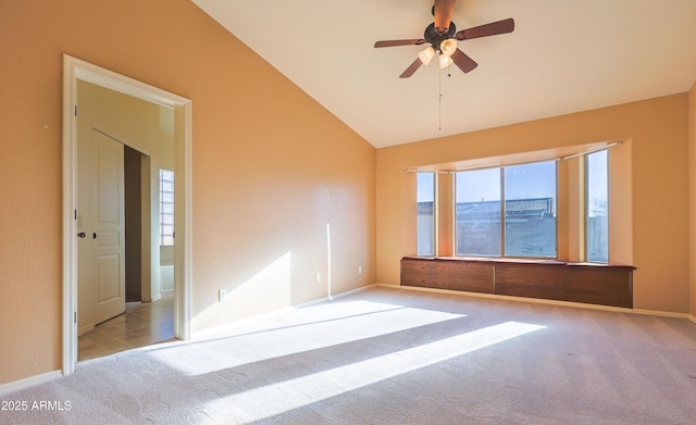 carpeted empty room with vaulted ceiling and ceiling fan