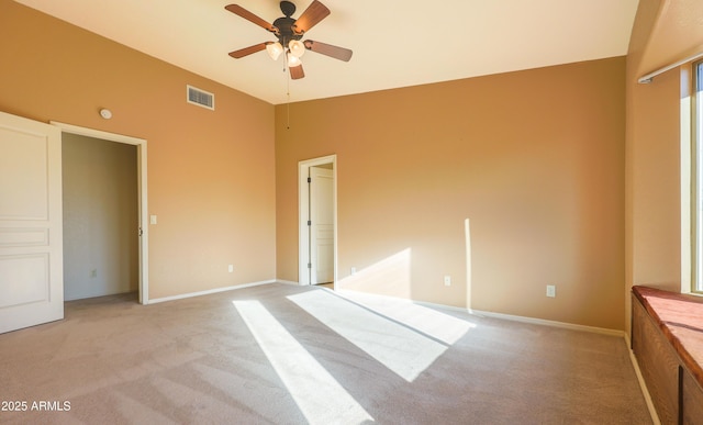 unfurnished bedroom with lofted ceiling, light carpet, and ceiling fan