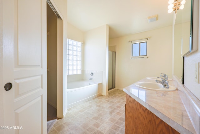 bathroom featuring vanity, plenty of natural light, and shower with separate bathtub