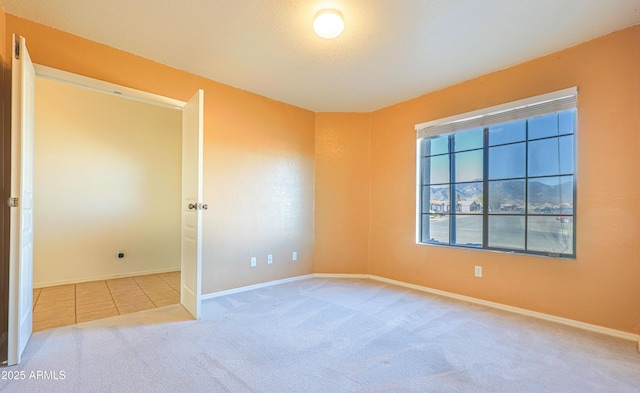 carpeted empty room with a textured ceiling