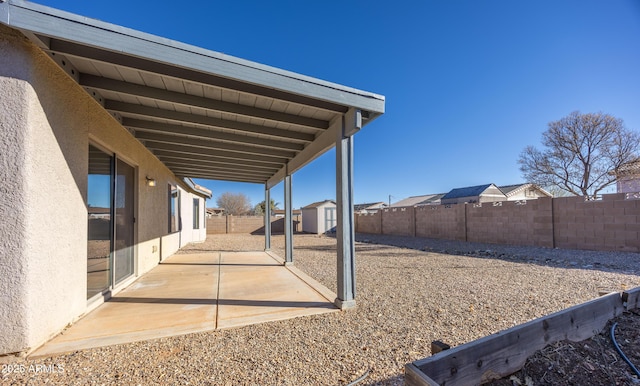 view of yard featuring a storage unit and a patio area