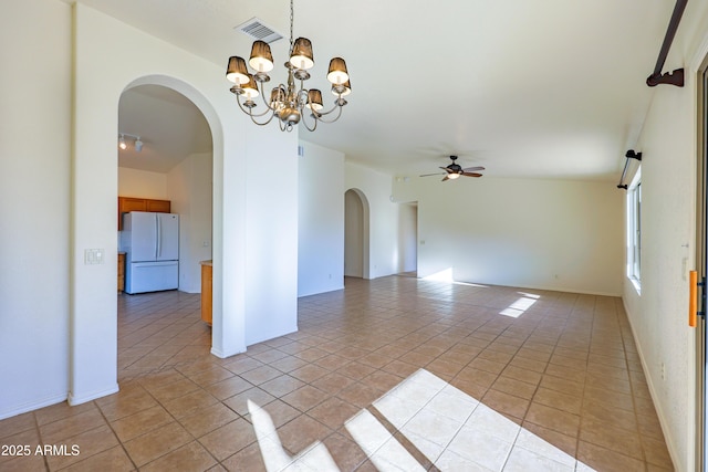 empty room featuring ceiling fan with notable chandelier and light tile patterned floors