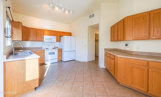 kitchen featuring sink, white appliances, high vaulted ceiling, and light tile patterned floors