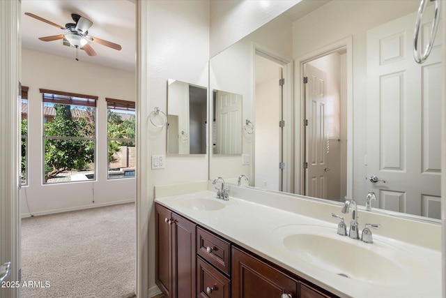 43998 W Palo Abeto Dr, Maricopa, AZ 85138 - bathroom featuring baseboards, double vanity, ceiling fan, and a sink