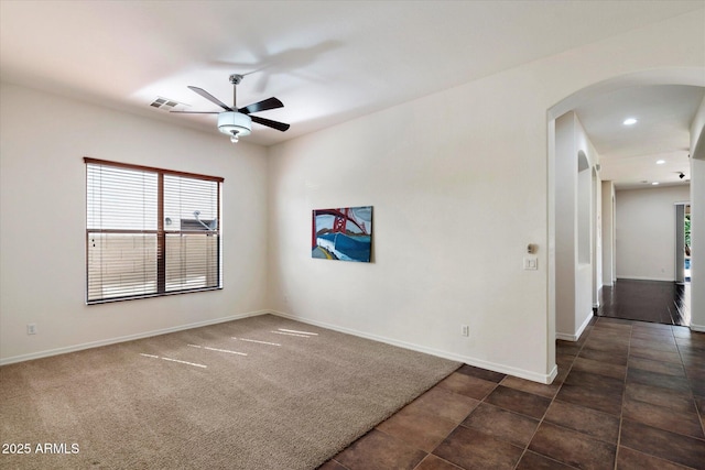 43998 W Palo Abeto Dr, Maricopa, AZ 85138 - spare room with baseboards, arched walkways, ceiling fan, and a wealth of natural light