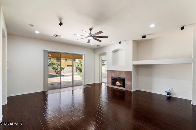 43998 W Palo Abeto Dr, Maricopa, AZ 85138 - unfurnished living room featuring ceiling fan, visible vents, a fireplace, wood finished floors, and recessed lighting