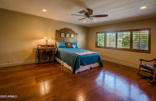 bedroom with ceiling fan and dark hardwood / wood-style flooring