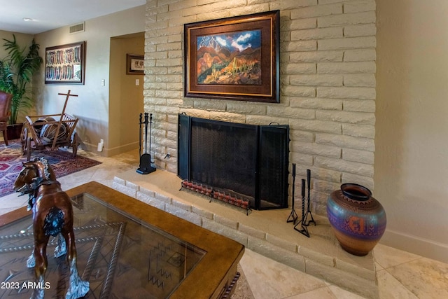 tiled living room featuring a brick fireplace